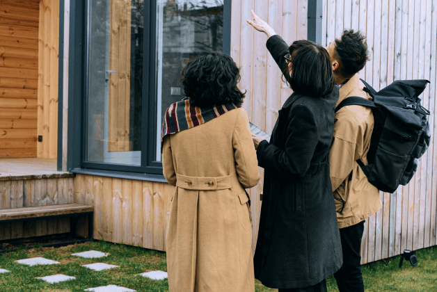 A realtor shows a young couple a house