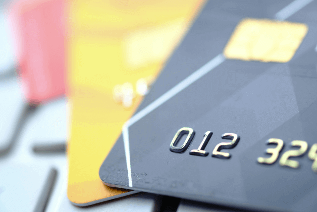 A fan of credit cards over a keyboard