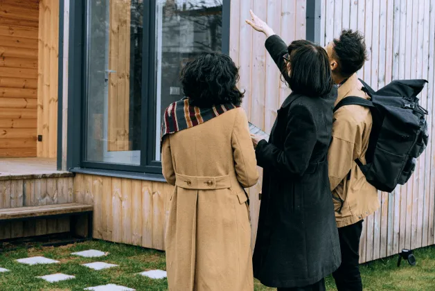 A realtor shows a young couple a house