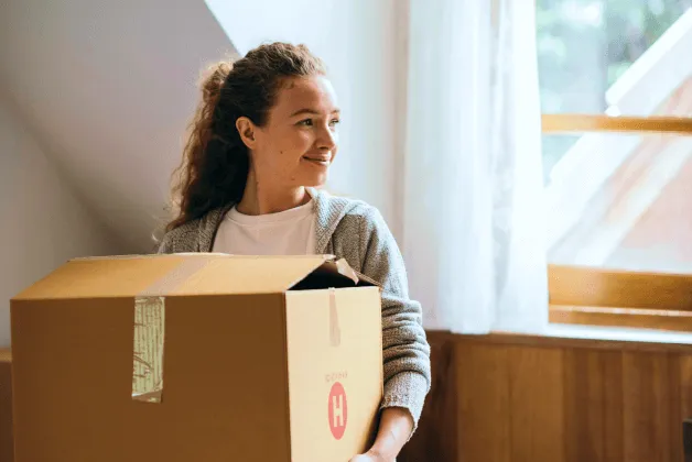 A young woman is happy to be moving into her new home