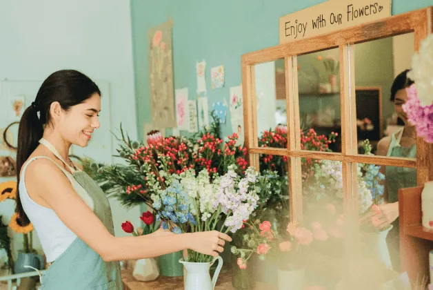 A young woman is excited to see her flower shop take off